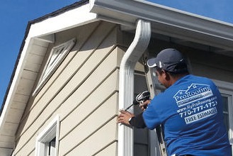 residential-contractor-gutters A residential contractor installing a white gutter