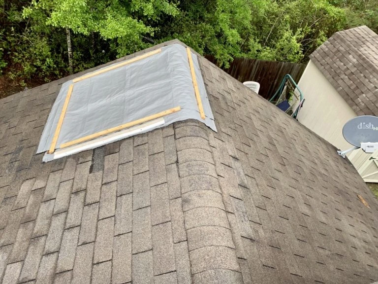 roof-tarp-installed-on-roof-by-a-roofing-contractor-after-storm-damage-from-a-tornado-or-hurricane roof tarp installed on roof by a-roofing-contractor after storm damage from a tornado or hurricane
