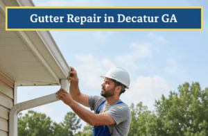 A male worker in a white hard hat and blue overalls is standing on a ladder, diligently repairing a white gutter system on the side of a light-colored residential home. Green trees and other suburban houses are visible in the background under a blue sky with scattered clouds. The image features a top banner in badge blue with the title "Gutter Repair in Decatur GA" in white text, bordered by canary yellow.